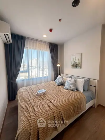 Cozy bedroom with large window and modern decor in urban apartment