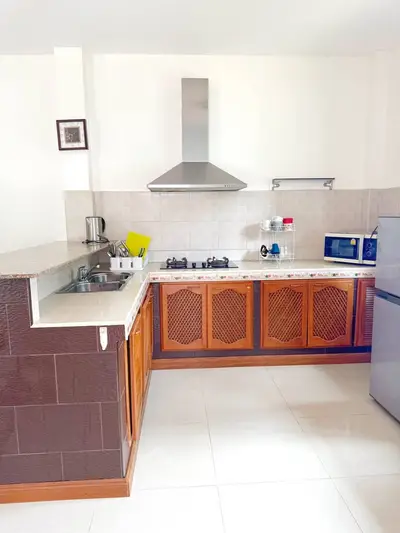 Spacious kitchen with modern appliances and gas stove in a stylish open layout.
