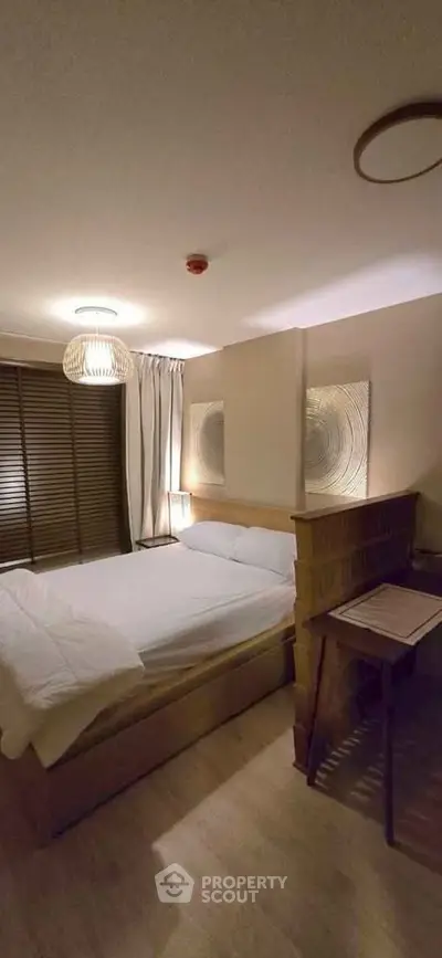 Cozy bedroom with modern decor and ambient lighting, featuring a comfortable bed and stylish wooden furniture.