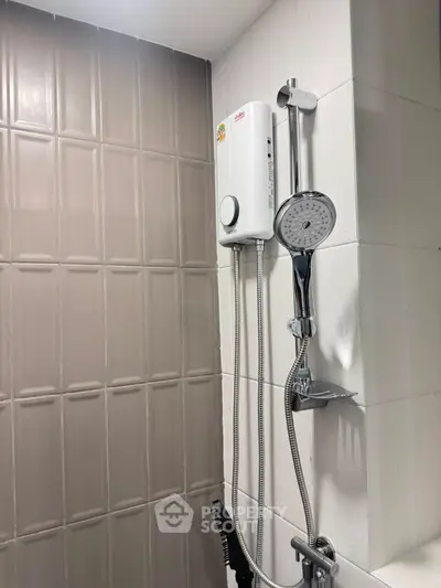 Modern bathroom shower with sleek design and water heater in contemporary home.