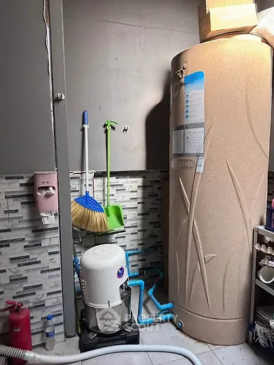 Utility room with water heater and cleaning supplies