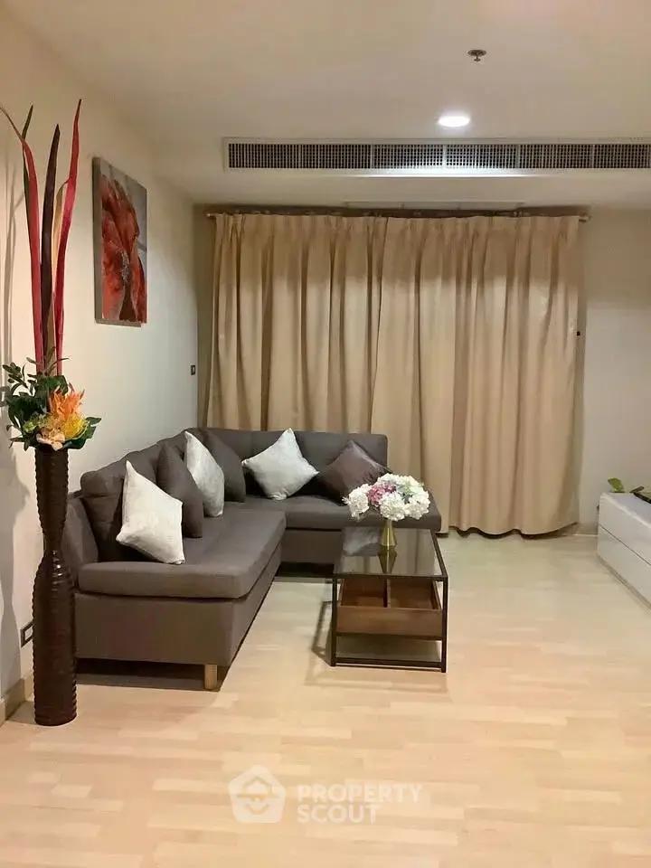 Spacious living room with modern sofa and elegant decor in a cozy apartment.