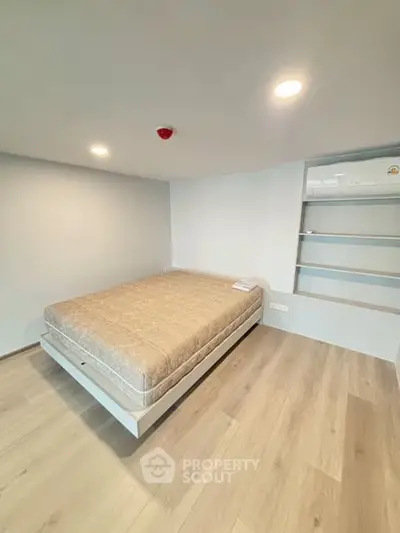 Modern minimalist bedroom with built-in shelves and cozy lighting