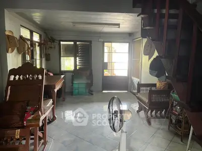 Charming rustic living room with wooden furniture and natural light, perfect for cozy gatherings.