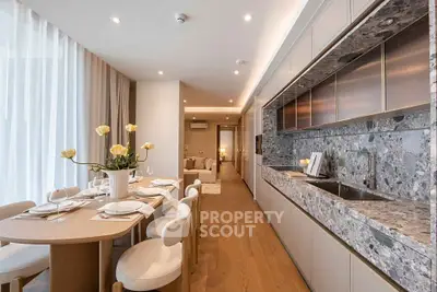 Luxurious open-layout kitchen and dining area with elegant decor and modern appliances.