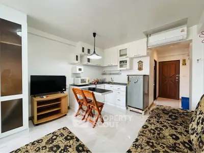 Charming open-layout kitchen and living area with modern appliances and cozy seating.
