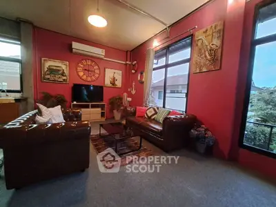 Stylish living room with leather sofas and vibrant decor in a cozy home setting.