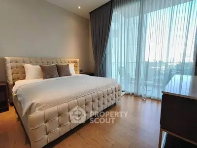Luxurious bedroom with elegant decor and large windows offering a stunning view.