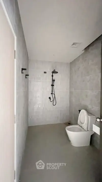 Modern minimalist bathroom with sleek shower and toilet design