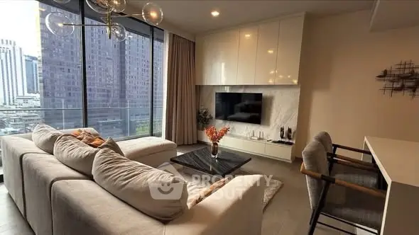 Modern living room with city view, cozy seating, and stylish decor