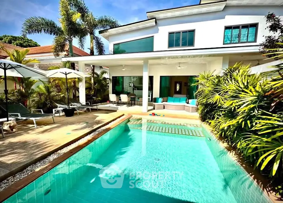 Luxurious villa with private pool and lush garden, perfect for tropical living.
