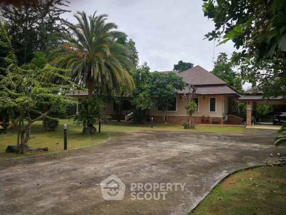 Charming single-story home with lush garden and spacious driveway, perfect for serene living.