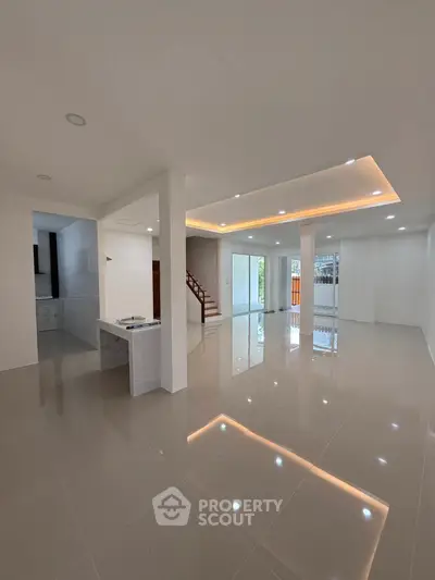 Spacious modern living room with glossy tiled floors and recessed lighting