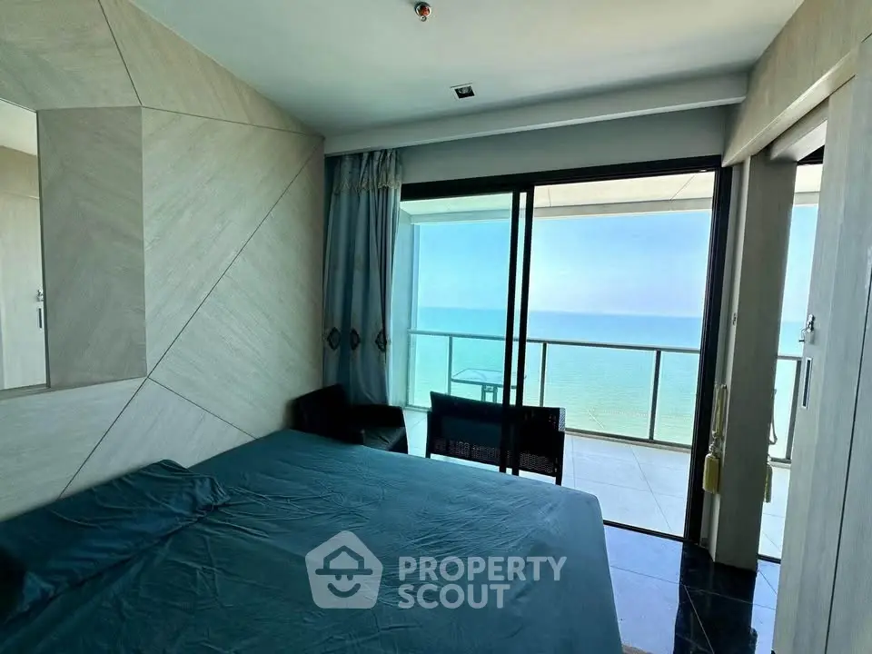 Luxurious bedroom with stunning ocean view and spacious balcony access.