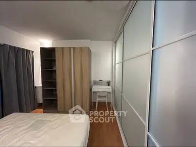 Modern bedroom with sliding closet doors and wooden flooring