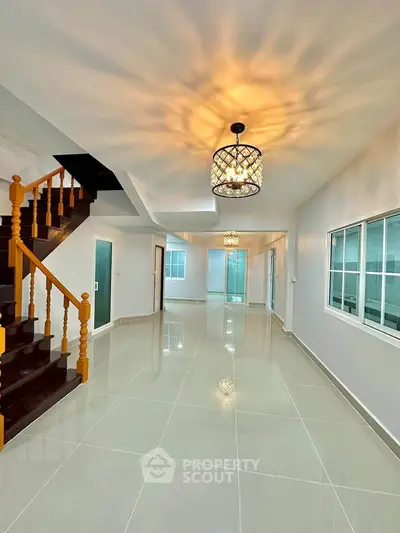 Spacious modern living room with elegant staircase and stylish lighting