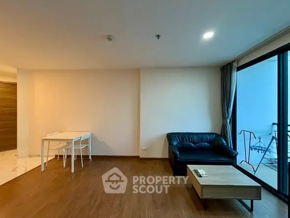 Modern living room with wooden flooring and minimalist furniture