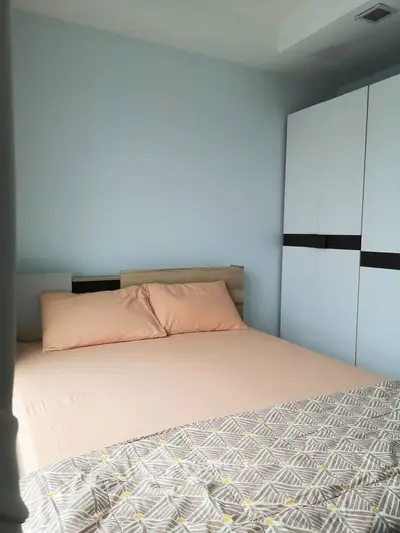 Cozy bedroom with modern wardrobe and stylish bedding