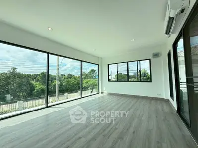 Spacious corner unit with large windows and serene garden view, perfect for modern living.