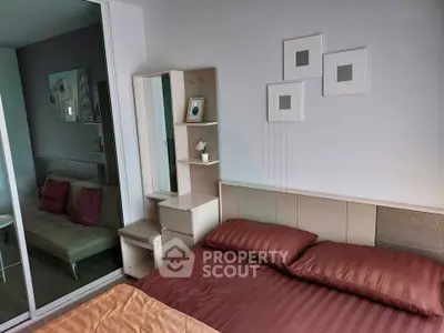 Modern bedroom with stylish decor and cozy ambiance, featuring a mirrored wardrobe and elegant wall art.