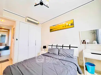 Modern bedroom with stylish decor and ensuite bathroom in a contemporary apartment.