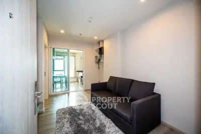 Modern living room with cozy sofa and stylish decor in a contemporary apartment.