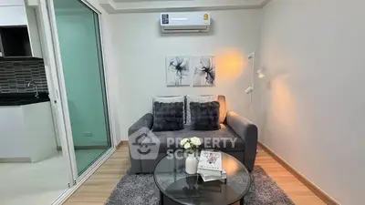 Cozy living room with modern decor and air conditioning, perfect for relaxation.