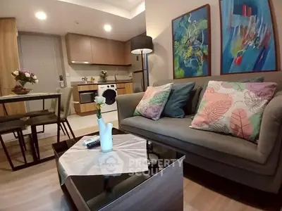 Modern living room with stylish decor and open kitchen layout, perfect for cozy urban living.