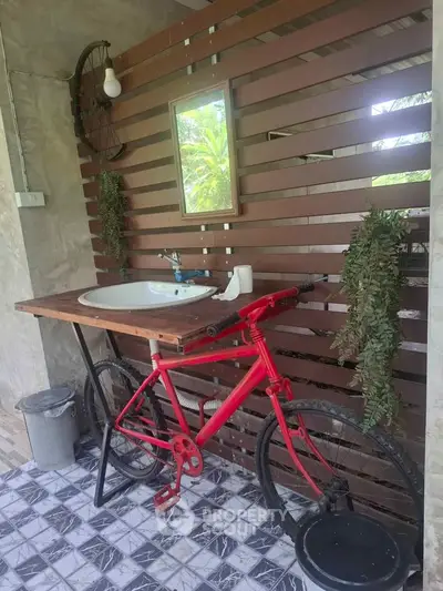 Unique bathroom with bicycle-themed sink and rustic wooden accents