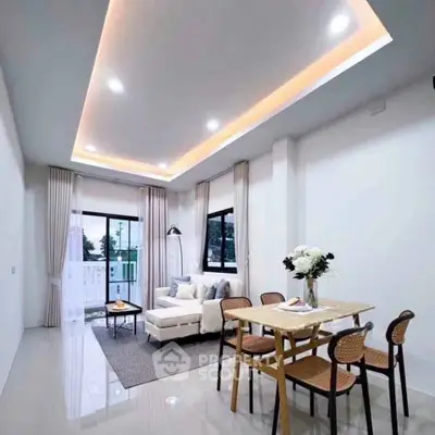 Modern living room with elegant lighting and stylish furniture in a bright open space.