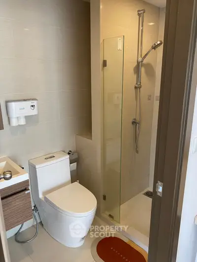 Modern bathroom with sleek shower and contemporary fixtures in a stylish apartment.