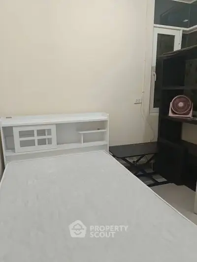 Cozy bedroom with minimalist design and ample natural light