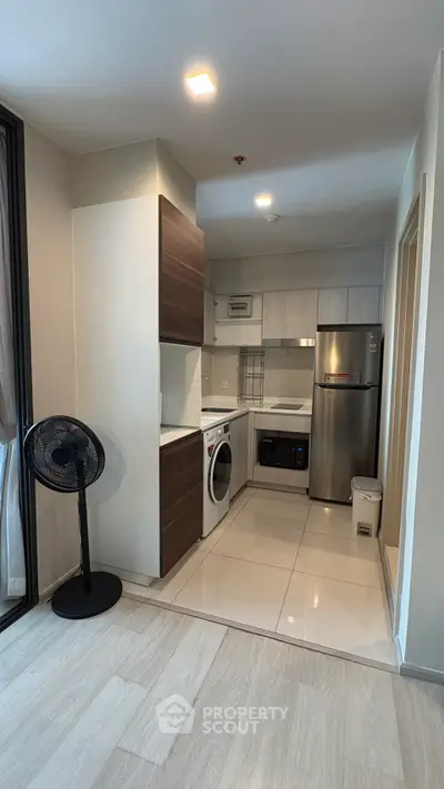 Modern kitchen with sleek appliances and open layout in a stylish apartment.