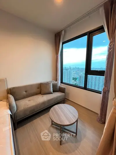 Modern living room with stunning city view, featuring a cozy sofa and elegant decor.