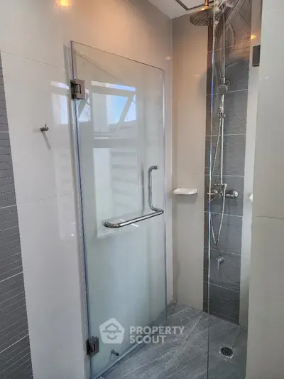 Modern bathroom shower with glass door and sleek fixtures