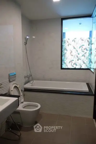 Modern bathroom with bathtub and stylish tile design