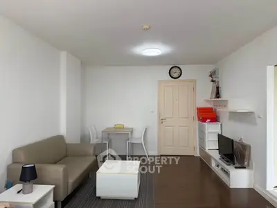 Modern living room with minimalist decor, featuring a cozy sofa, dining table, and wall-mounted shelves.