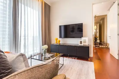 Modern living room with stylish decor and large window offering natural light.