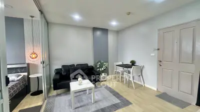 Modern living room with sleek furniture and stylish decor in a cozy apartment setting.
