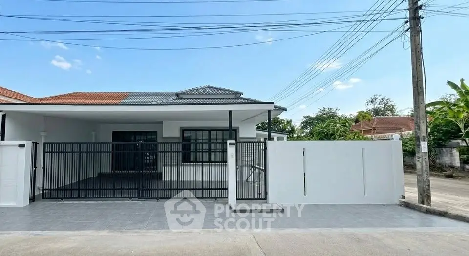 Charming single-story home with gated entrance and spacious driveway in a serene neighborhood.