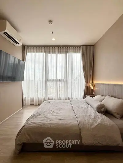 Spacious modern bedroom with large window and elegant decor