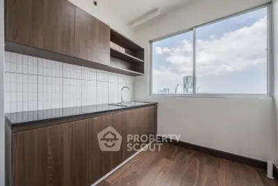 Modern kitchen with wooden cabinets and city view from window