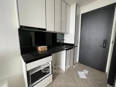 Modern kitchen with sleek cabinetry and built-in appliances in a contemporary apartment.