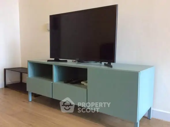 Modern living room with sleek TV stand and flat-screen television