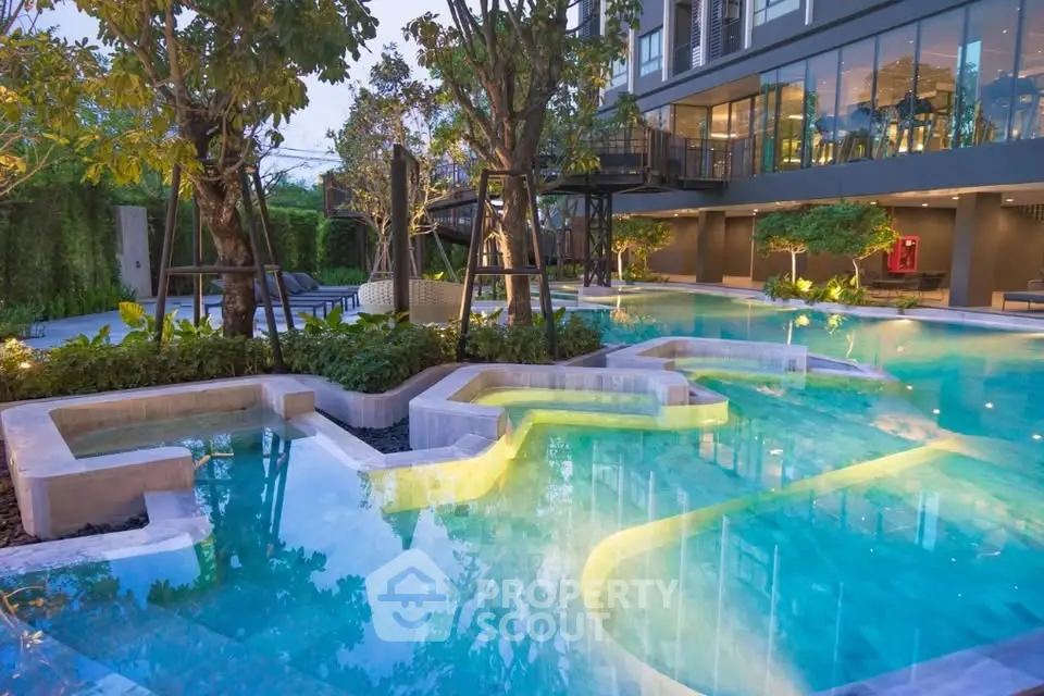 Luxurious modern pool area with lush greenery and stylish architecture