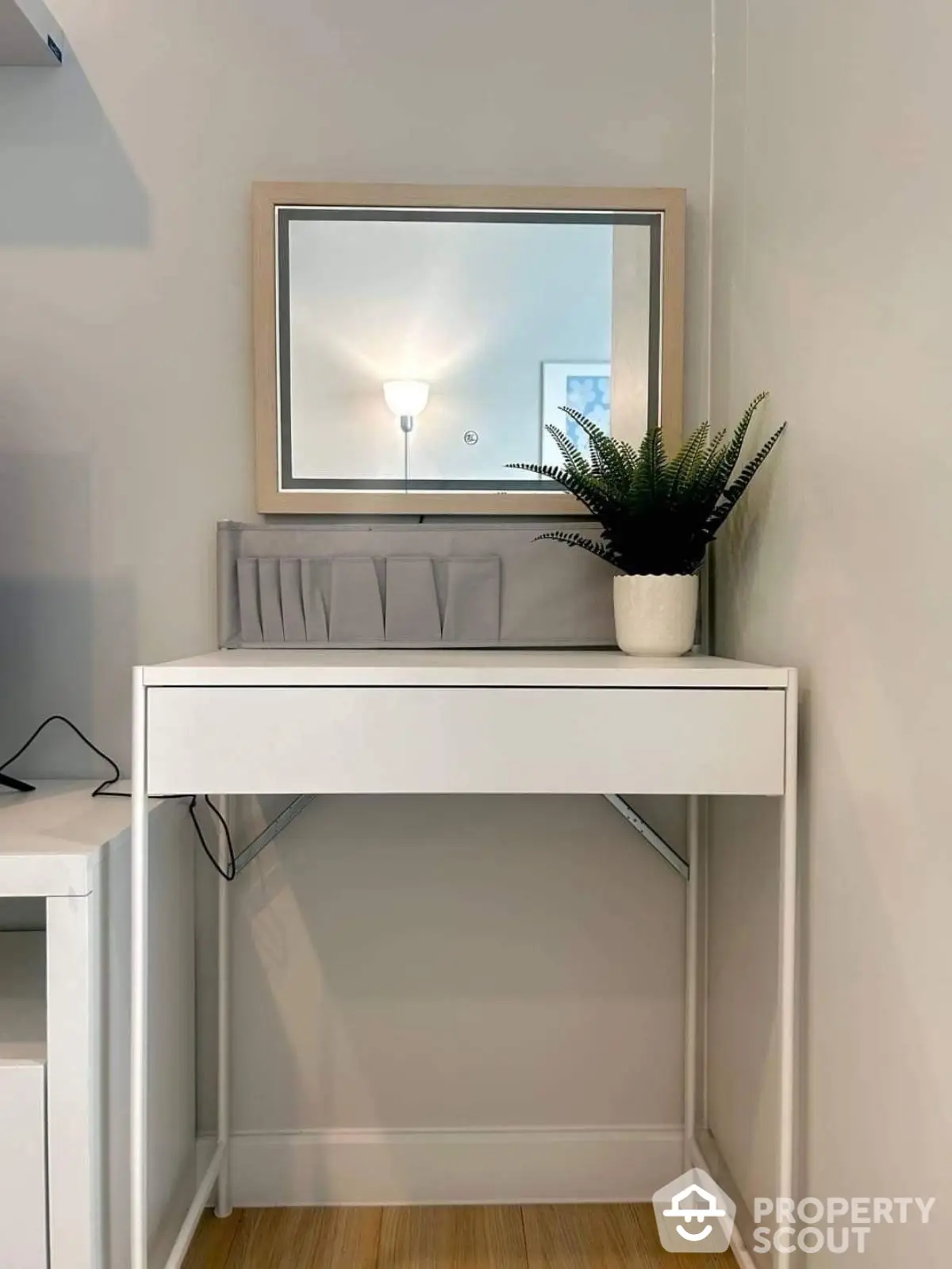 Modern minimalist vanity with mirror and potted plant in stylish corner setup