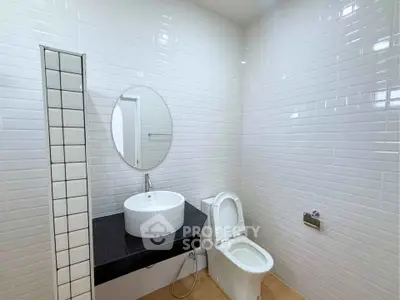 Modern bathroom with sleek white tiles and contemporary fixtures