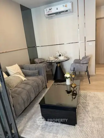 Modern living room with stylish furniture and air conditioning, perfect for comfort and relaxation.