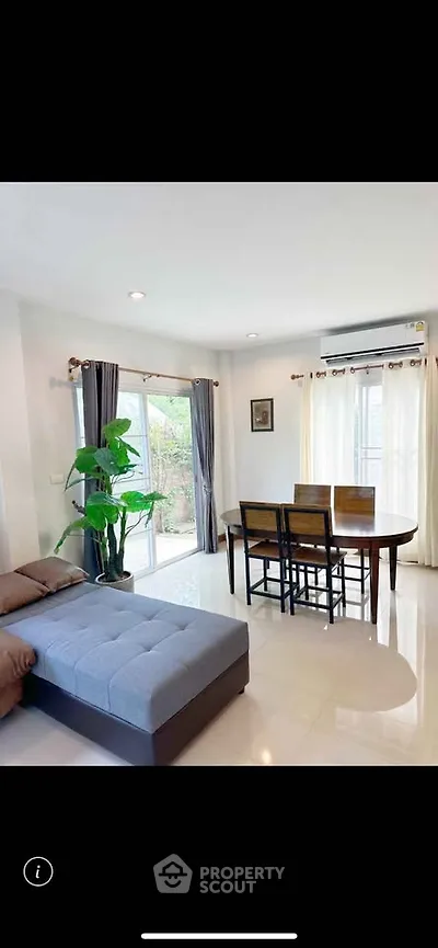 Bright and airy living room with modern furniture and large windows in a stylish home.