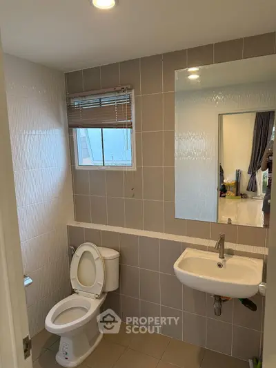 Modern bathroom with sleek fixtures and neutral tiles